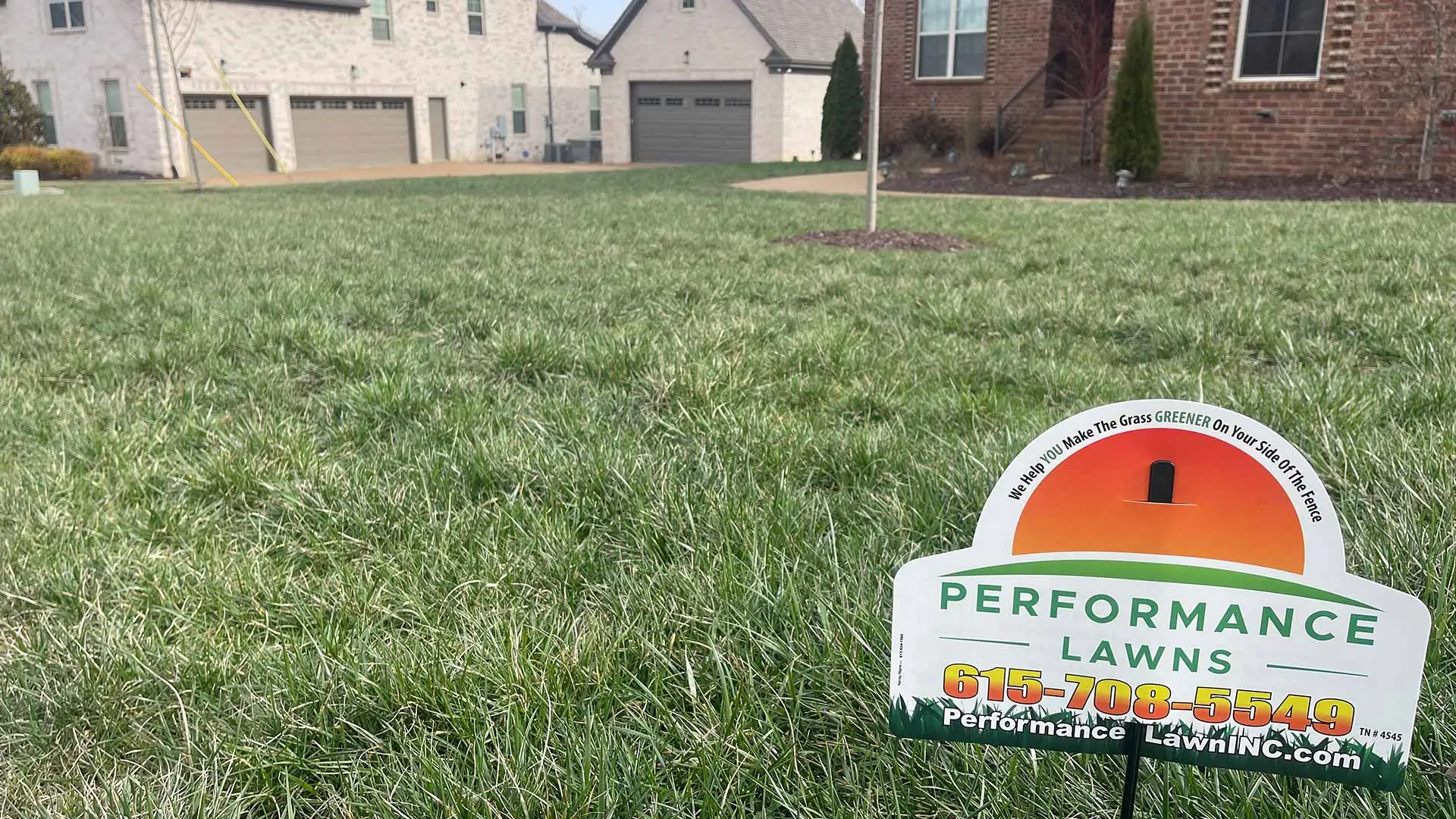 Signage from Performance Lawns Inc. displayed on a lawn in Gallatin, TN.